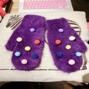 Cute fuzzy plush winter mittens for women, purple knit gloves with colorful pom poms.