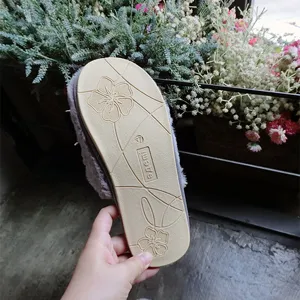 Cozy grey faux wool indoor slippers detail view showcasing non-slip flower pattern sole size 37.
