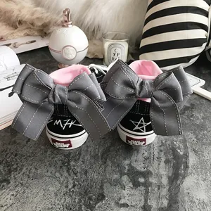 Black high-top canvas sneakers with grey bow and pink lining, trendy streetwear casual shoes.
