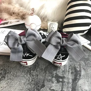 Black canvas sneakers for women featuring large grey bowknot decoration on the back heel.