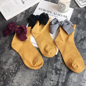Cute bow mid-calf socks for women, sweet style yellow cotton stacked socks with large ribbon.