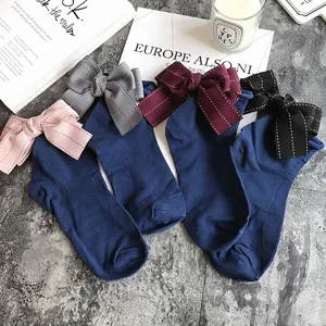 Cute bowknot cotton socks with cute back bows, solid dark blue stackable socks flat lay.