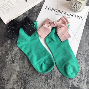 Cute Korean style women cotton socks featuring large elegant ribbon bows for sweet daily wear.
