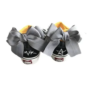 Black canvas sneakers featuring oversized grey bowknot decoration on heel for cute daily wear.