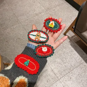 Handmade crochet Christmas hair clips detailed view featuring cute cartoon motifs wool fabric