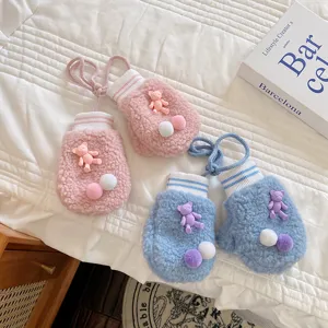 Cute winter baby mittens in pink and blue sherpa fleece with 3D bear and colorful pompoms.
