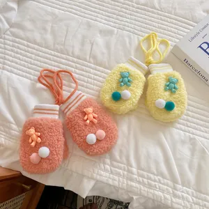 Cute winter toddler plush mittens with cartoon bear and colorful pom poms, thick warm gloves.