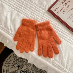 Orange knit winter gloves for women, cozy plush five-finger design, warm woolen daily wear.