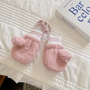 Cute pink lamb fleece baby mittens with striped cuffs and hanging string, winter warm toddler gloves.