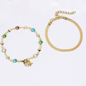 Gold tone double layered bracelet and necklace set with colorful crystals and dolphin charm.