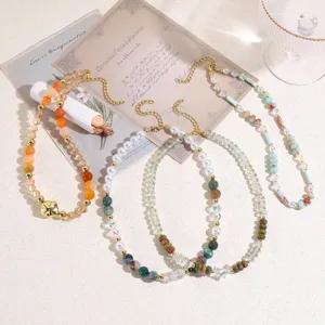 Detailed shot of dopamine colorful crystal beaded necklaces with irregular pearls and elegant charms.