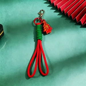 Close-up detail of the Christmas tree pendant and green wrapped braided cord keychain charm.