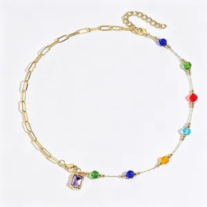 Detailed view of gold-tone multi-color crystal bead pendant necklace and chic link chain accessory.