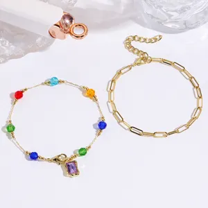 Detailed shot of multi-color crystal beaded gold chain and paperclip bracelet set.