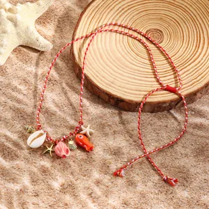 Resort style red braided rope necklace featuring charming ocean seashell and starfish pendants.