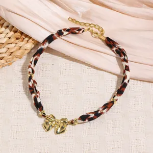 Leopard print fabric braided double layer choker necklace with gold tone metal bow charm