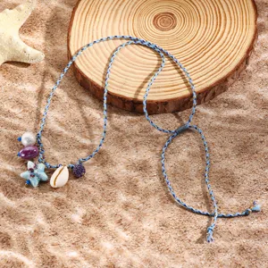 Close-up of boho braided rope necklace with shell and starfish charms for beach resort style.