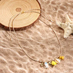 Beach style braided necklace with shell and starfish pendants, perfect for summer vacation.