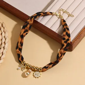 Detailed view of leopard print fabric necklace with metal beads and charms for daily wear.