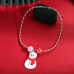Detail view of Christmas snowman pendant necklace with festive beads and braided rope.