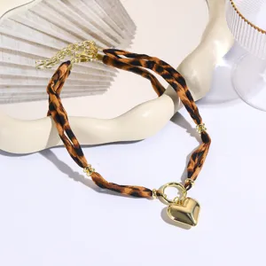 Elegant leopard print fabric choker necklace with gold heart pendant for women fashion.