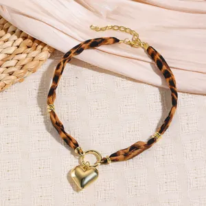 Leopard print fabric choker necklace with gold heart pendant and extension chain for women accessory.