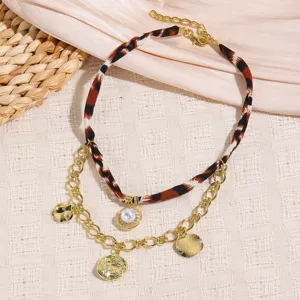 Elegant multi-layer leopard print scarf necklace with pearl and gold coin pendants for women.