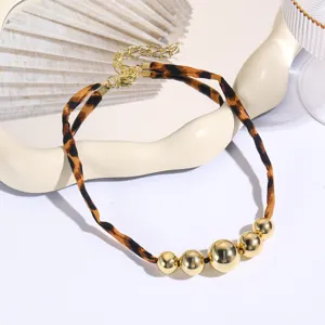 Leopard print fabric necklace with glossy gold-tone metallic beads and adjustable chain.
