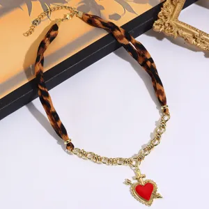 Detailed view of the vintage leopard print scarf necklace featuring a striking red heart pendant.