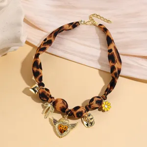 Detailed view of the French vintage leopard print fabric choker necklace with chic gold charms.