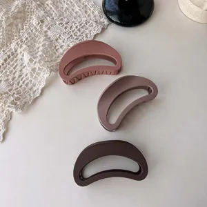 Detailed view of retro autumn winter brown frosted large hollow crescent hair claw clip.