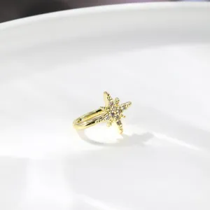 Gold star ear cuff detail shot, sparkling rhinestone design, non piercing clip on jewelry.