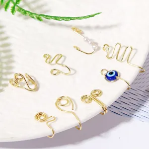 Detail view of handmade gold wire-wrapped clip-on nose rings set, vintage style