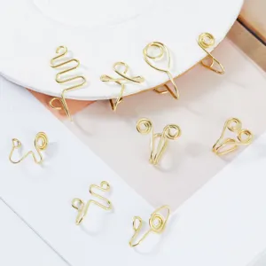 Detailed view of assorted gold wire fake nose rings and ear cuffs, non-piercing geometry set.