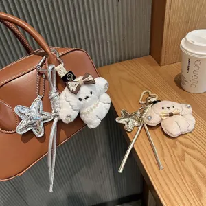 Cute plush puppy bag charm with star pendant and leather braided rope, perfect detail view.