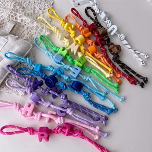 Colorful handmade braided rope lanyards with alphabet letter beads, detailed close-up shot.