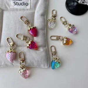 Cute gradient resin strawberry keychains with gold clasps, perfect sweet bag pendants.