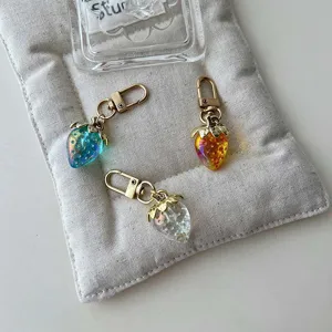 Detailed view of cute gradient strawberry keychain and bag pendant, sweet style jewelry accessory.
