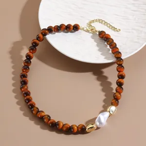 Retro faux tiger's eye beaded necklace detail with baroque pearl and gold chain.