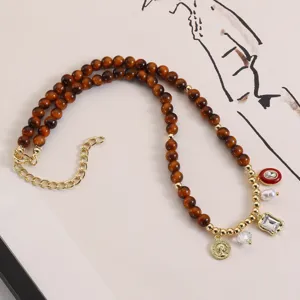 Retro Maillard brown beaded necklace with chic gold pendants, vintage style fall fashion jewelry.