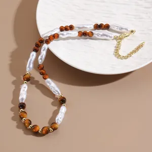 Close up view of the retro Maillard beaded necklace, featuring baroque pearls and tiger eye style beads.