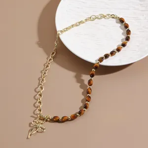 Vintage half-chain and beaded necklace with elegant bow pendant for autumn and winter style.