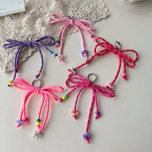 Colorful woven bow keychain and bag charm with cute floral beads, dopamine sweet style accessory.