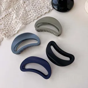 Detailed view of matte crescent hair claw clips in assorted autumn colors, elegant design.