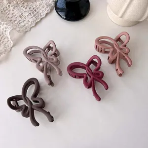 Matte butterfly hair claw clip detail, stylish autumn winter shark clip for elegant women.