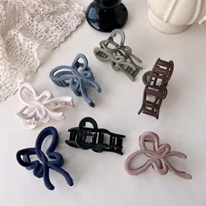 Matte hollow hair claw clips in various colors, stylish large shark clips for elegant hairstyles.