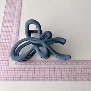 Large matte blue hair claw clip with unique abstract artistic design for thick hair styling
