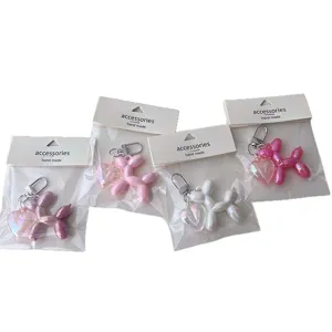 Acrylic balloon dog keychain set with colorful mini heart pendant for cute bags and keys.