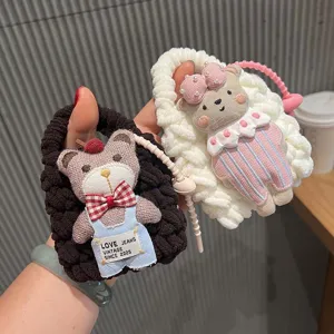 Handcrafted knitted bear keychain earphone storage bag detail shot showing cute plush cartoon design.