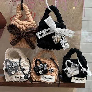 Handmade knitted earphone pouch cute mini wool bag with bow and pearl detail detail shot.